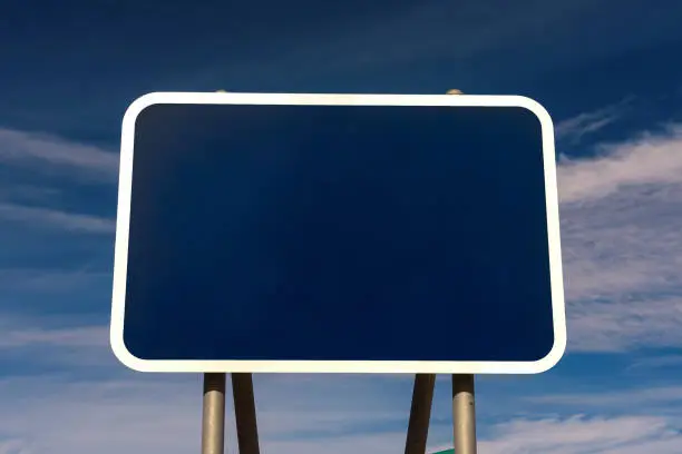 Photo of Blank road sign with blue background