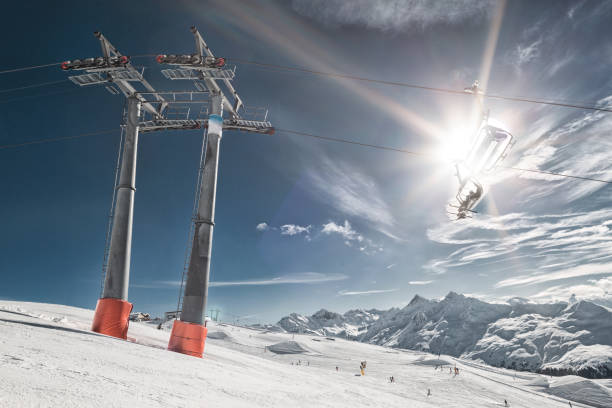 istock Ski lift with chair and people back lit in Davis, Switzerland 985684076