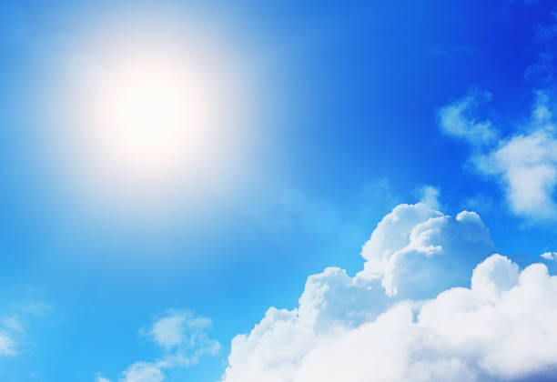 istock Cropped bright sun shining over floating cumulus clouds 985687872