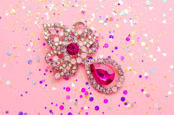 istock brooch with pendant and pink diamonds in spangles isolated on pink background 985713262