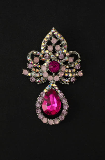 istock Brooch with pink diamonds isolated on black 985713772