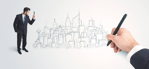 istock Businessman looking at hand drawn city on wall 985761584