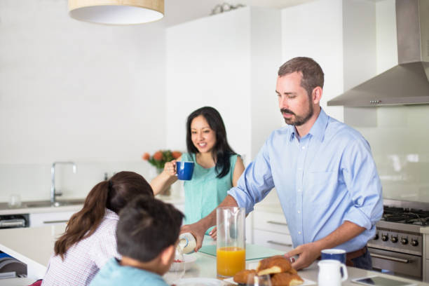 istock Family having breakfast at kitchen island 985763256
