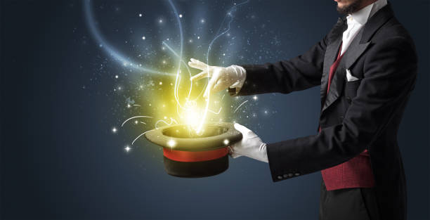 istock Magician hand conjure miracle from cylinder 985778122