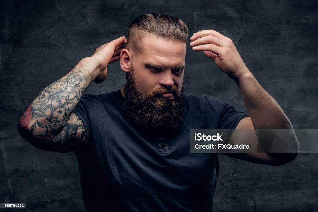 Bearded Male Touches His Hairstyle With Tattooed Arms Stock Photo -  Download Image Now - iStock