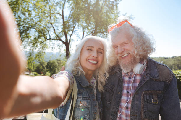 istock Cheerful aged woman holding a camera 985784370