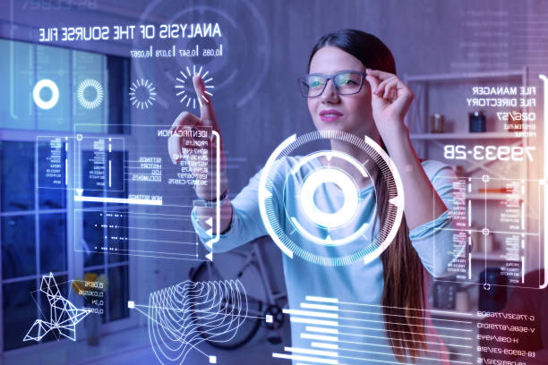 istock Clever woman smiling and touching her glasses while looking at the screen 985786694