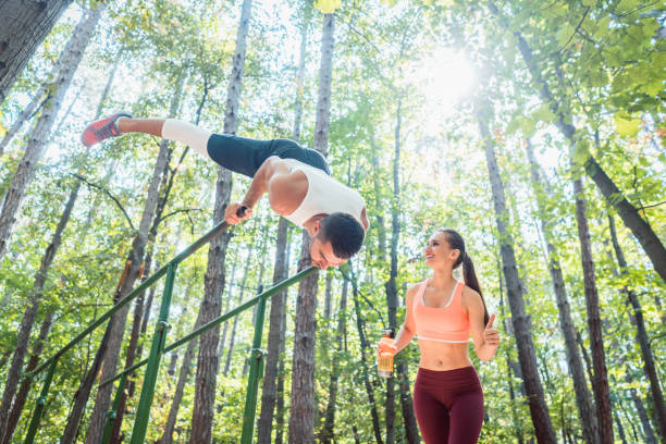 istock Sportive couple doing workout in outdoor gym 985786906