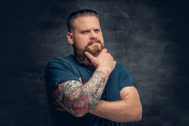 istock Bearded fat male with tattoo on arms. 985793842