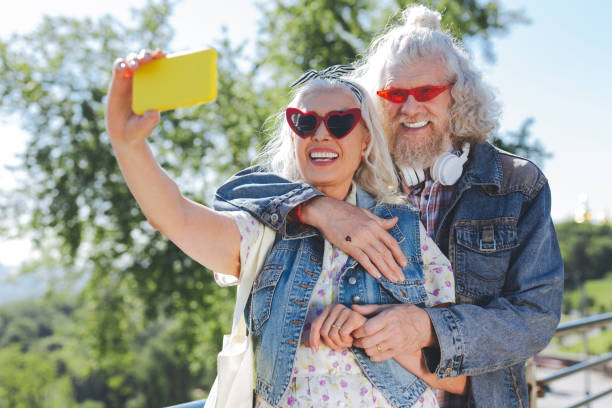 istock Nice cheerful woman holding her smartphone 985795534