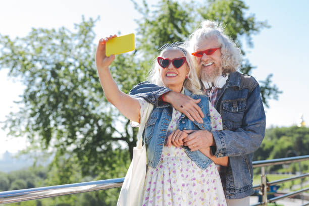 istock Joyful aged woman taking selfies with a smartphone 985796122