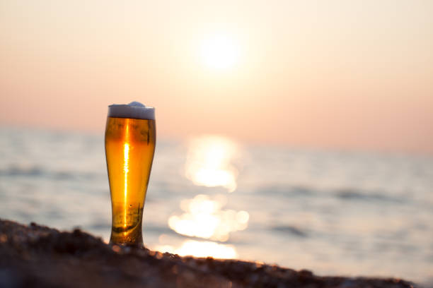 istock Glass of beer on a sunset 985796396