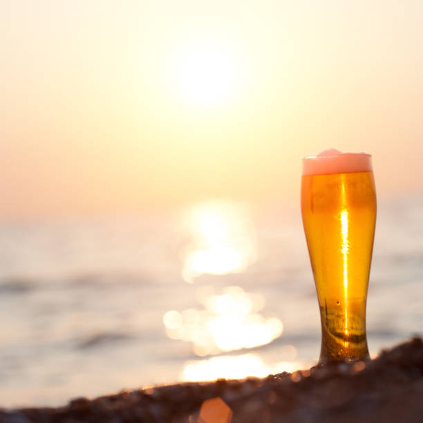 istock Glass of beer on a sunset 985796428