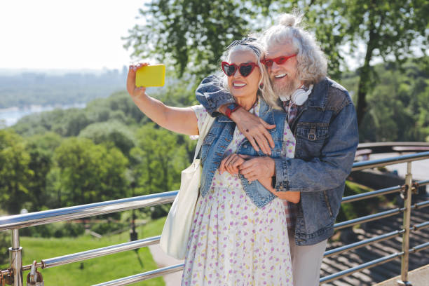 istock Nice cheerful couple posing for a photo 985796678