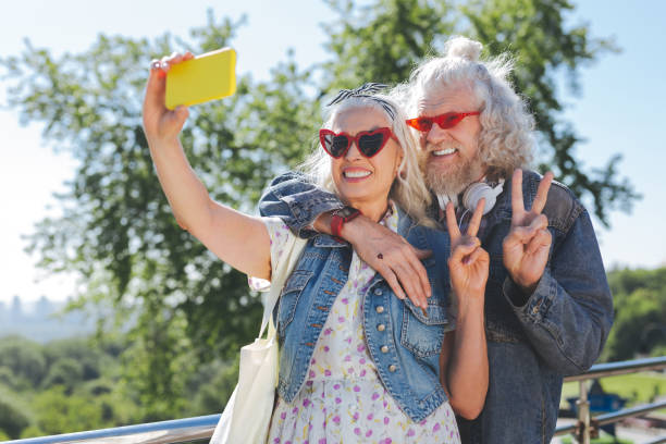 Happy nice couple showing V sign