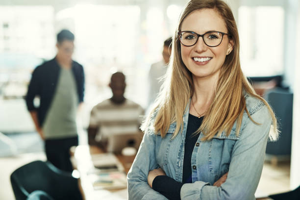 istock Confident young businesswoman smiling while standing in an office 985799822
