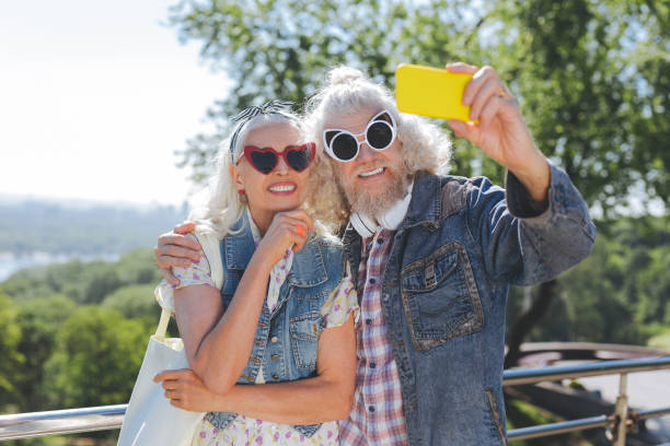 istock Delighted aged people wearing sunglasses 985800746