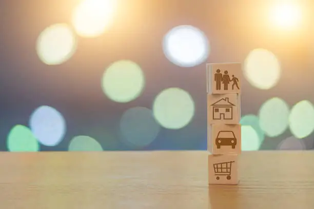 Family lifestyle and budget on wooden cubes on a beautiful bokeh background with light