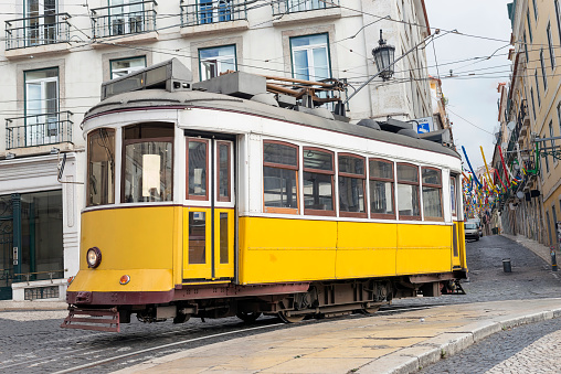 Old portuguese traditional electric yellow tram  central Lisbon streets
