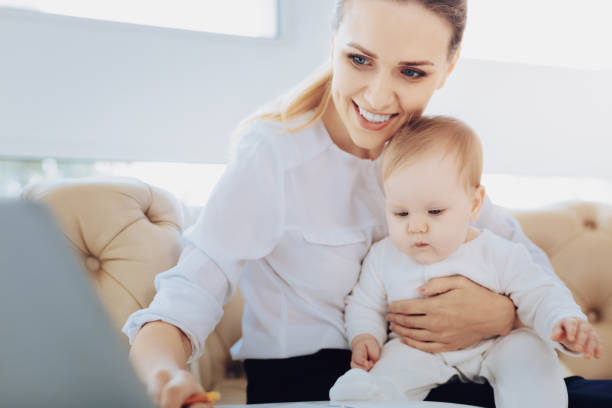 istock Joyful young woman spending time with baby 985807536