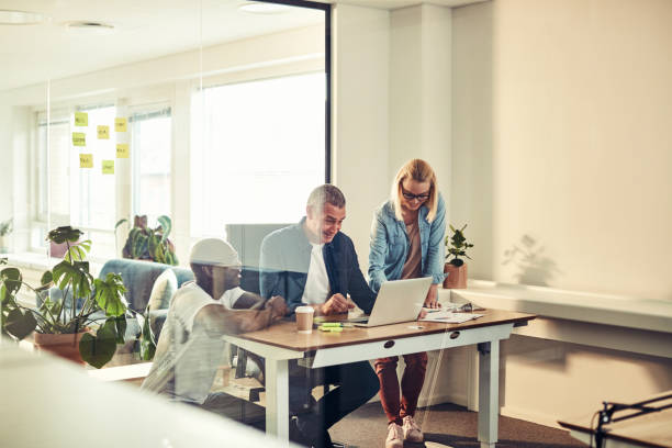 istock Diverse businesspeople smiling while working together in an office 985808076
