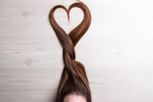 long hair forming a tress ending with a shape of heart
