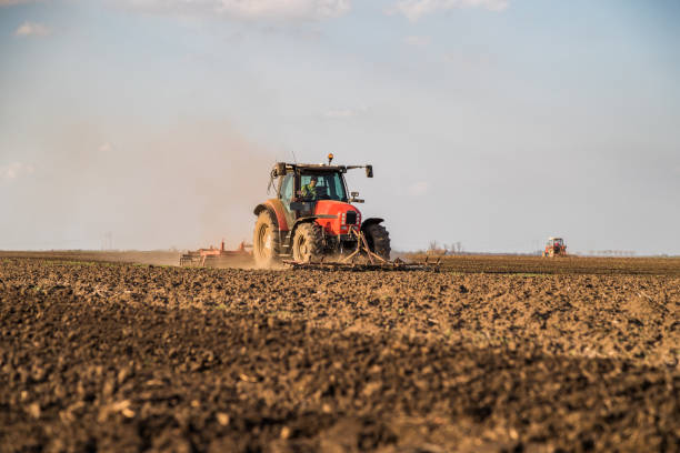 istock Farmer in tractor preparing land with seedbed cultivator 985822780