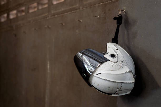 old helmet hanging on the brick wall with soft-focus and over light in the background