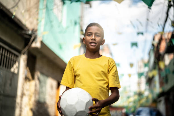 istock Brazilian Kid Playing Soccer Portrait 985830546
