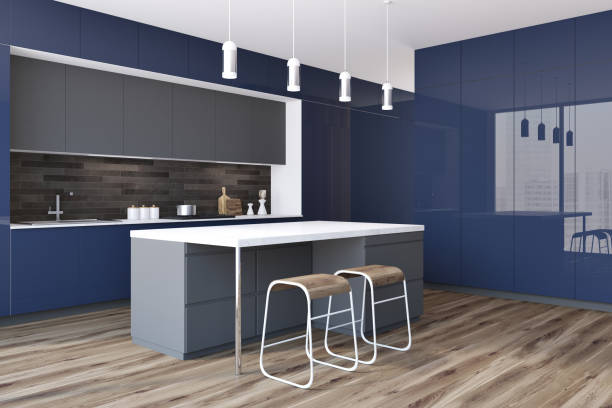 istock Black and blue kitchen with a bar, side view 985831560