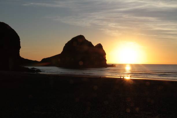 istock Sunset at Piha Beach, New Zealand 985833210