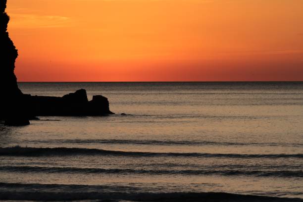 istock Sunset at Piha Beach, New Zealand 985835748