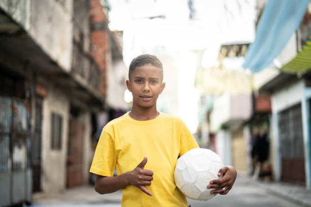 istock Brazilian Kid Playing Soccer Portrait 985836274