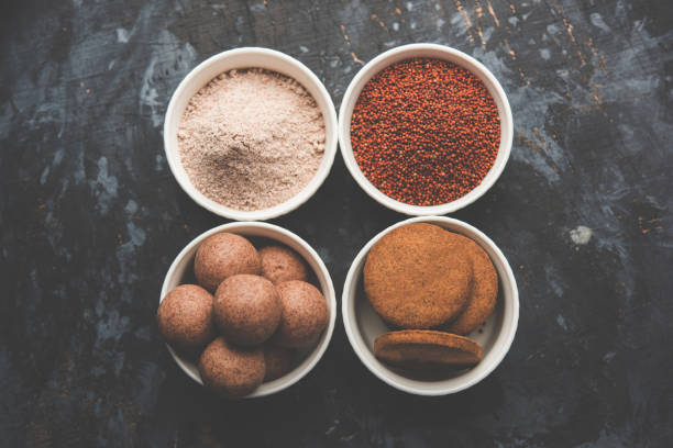 istock Nachni / Ragi laddu and biscuits or cookies made using  finger millet, sugar and ghee. It's a healthy food from India. Served in a bowl or plate with raw whole and powder. Selective focus 985838444