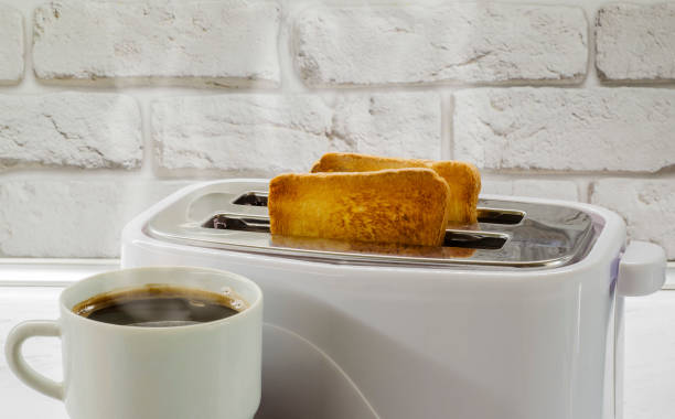 istock a cup of coffee and toast in a toaster2 985842120
