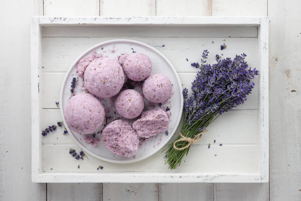istock Handmade lavender bath bombs and flowers in white tray 985846994