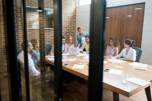istock Group of people in a meeting working online at a creative office 985849364