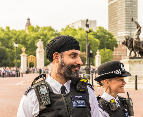 London. June 9 2018. A view of an asian and female police officer during the Queens birthday celebrations of Trooping the Colour