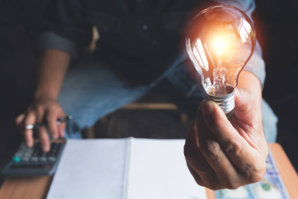 istock Hand of male holding a light bulb for innovation and creative concept . 985870232