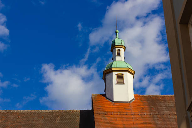 catholich church with blue yellow facade on blue sky sunshine springtime day in south german city schwaebisch gmuend near stuttgart