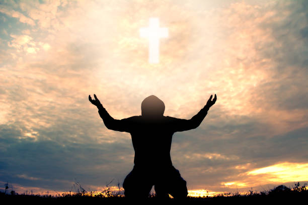 istock Silhouette Man Kneeling Against Sky During Sunset 985872156
