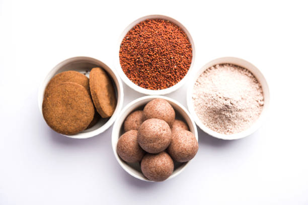istock Nachni / Ragi laddu and biscuits or cookies made using  finger millet, sugar and ghee. It's a healthy food from India. Served in a bowl or plate with raw whole and powder. Selective focus 985875594