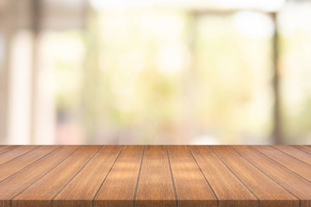 istock Empty wood table on blurred background copy space for montage your product or design , Blank brown board with abstract blurred background. 985875766