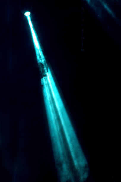 istock abstract image with rays of colored light in the dark 985878026
