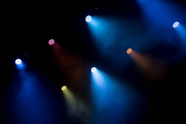 istock abstract magic image with rays of colored light from the spotlights in the dark 985878232