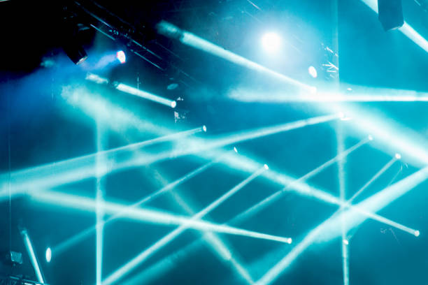 istock abstract magic image with rays of colored light from the spotlights in the dark 985878282