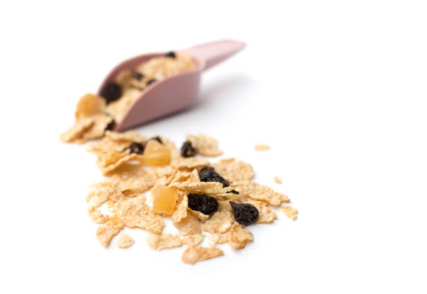 whole grain cereal flakes which mixed berry fruit and raisins for breakfast isolaed on white background