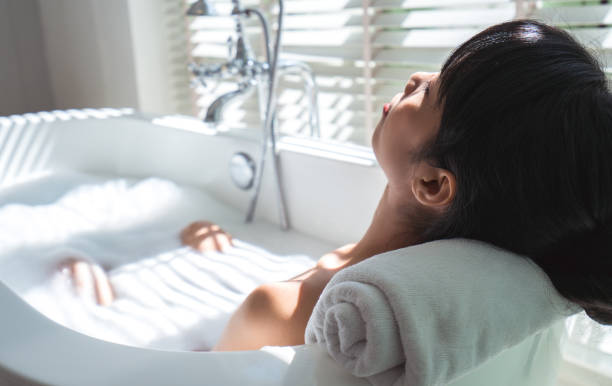 istock Woman relaxing in bathtub 985882750