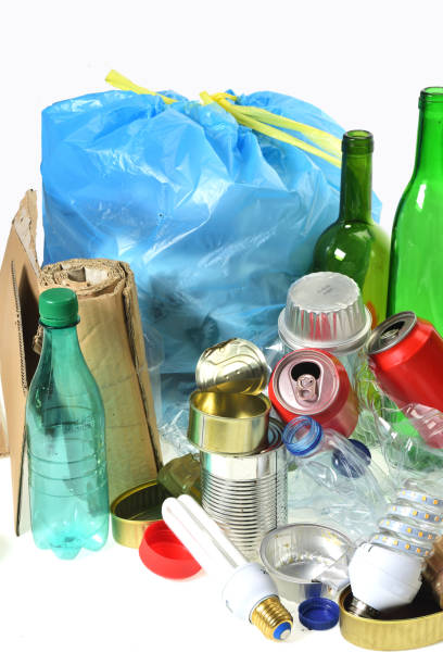 istock trash for recycling with, glass bottles, cans, plastic bottle and bulb 985884172