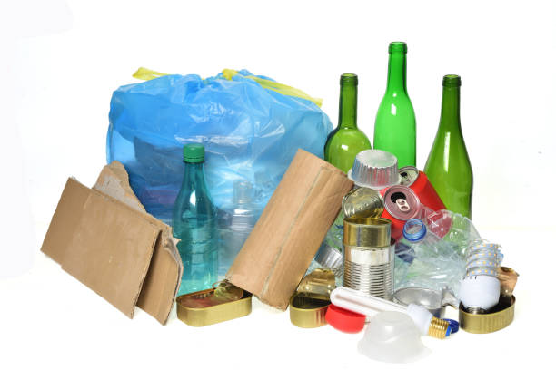 istock trash for recycling with, glass bottles, cans, plastic bottle and bulb 985884246